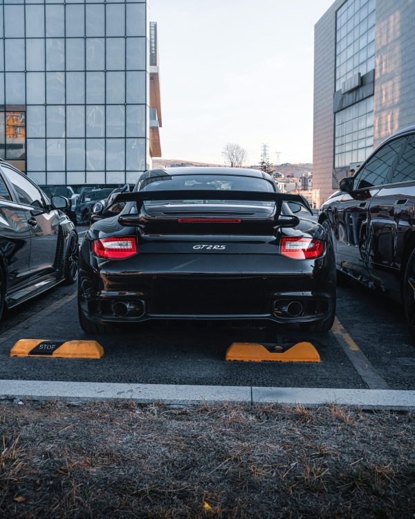 Rear view of a black GT2 RS car parked in Ankara city area.